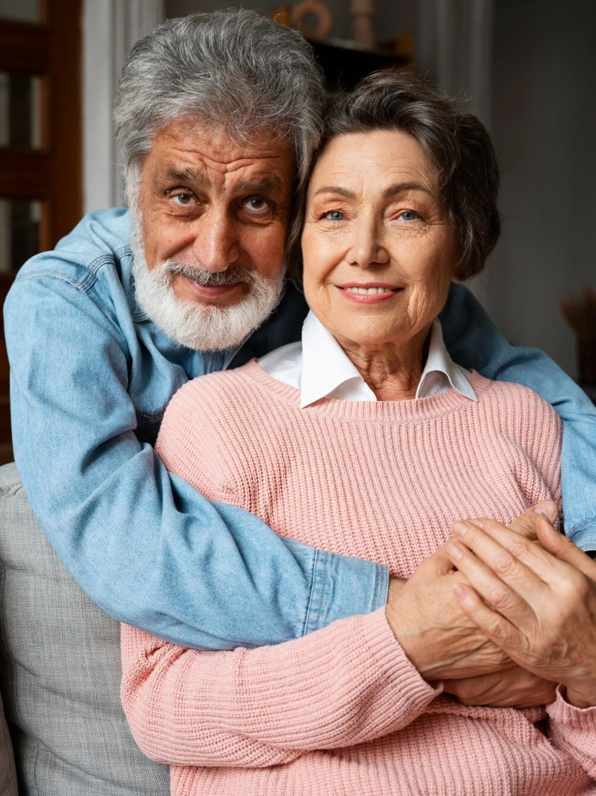 Older adult receiving a supportive hug from loved one.