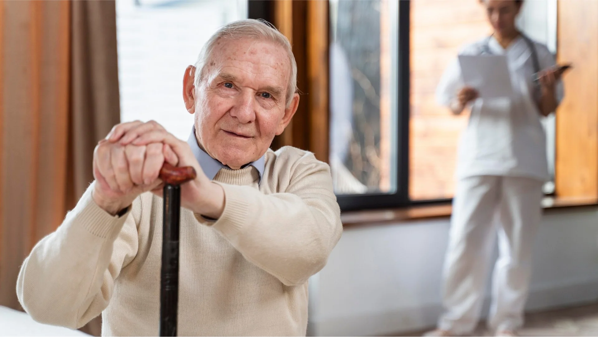 Senior man doing light exercise indoors.