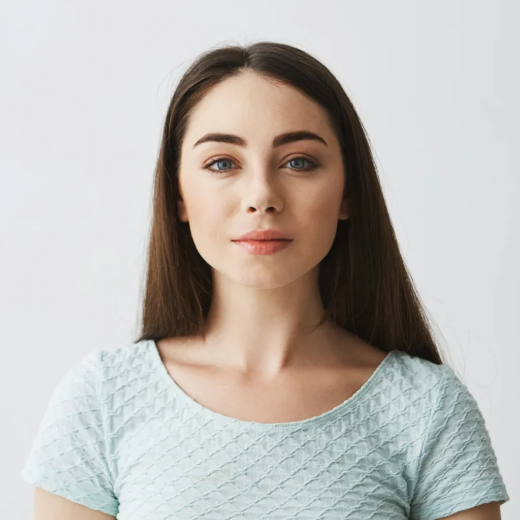 Portrait of woman with straight dark hair in light top.