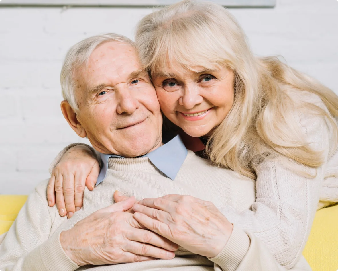 Elderly woman and younger woman hugging warmly.