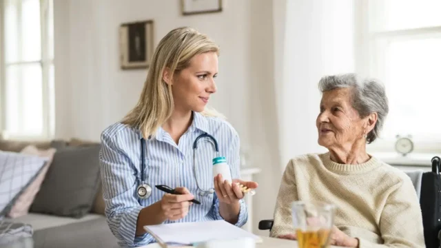 Nurse explaining medication to senior patient