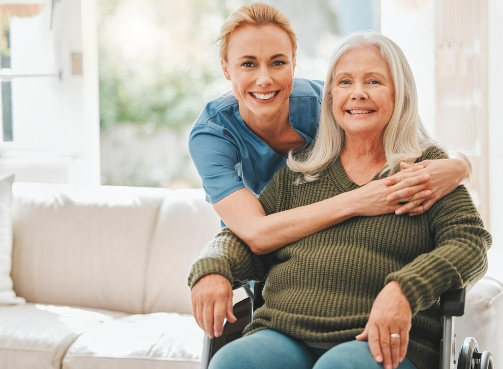 Woman giving an affectionate hug to older lady.