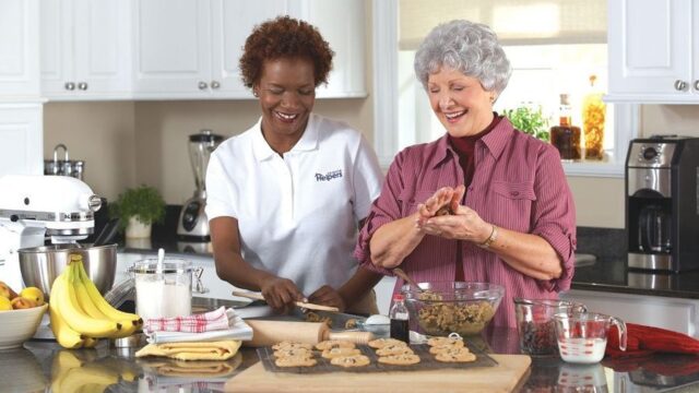 Two women baking together in a modern kitchen.