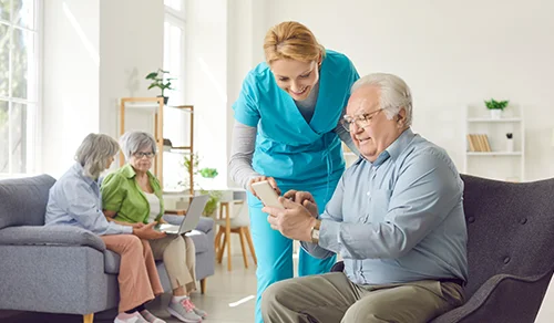 Man showing something on tablet to the nurse.