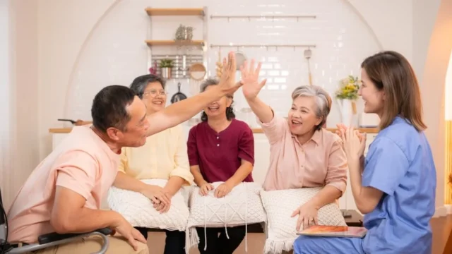 Seniors giving high-fives in a cheerful group activity.